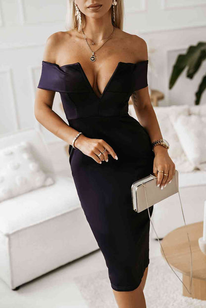 woman wearing a v plunge off shoulder dark navy midi dress