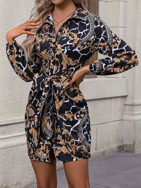 woman wearing a black and gold print mini shirt dress