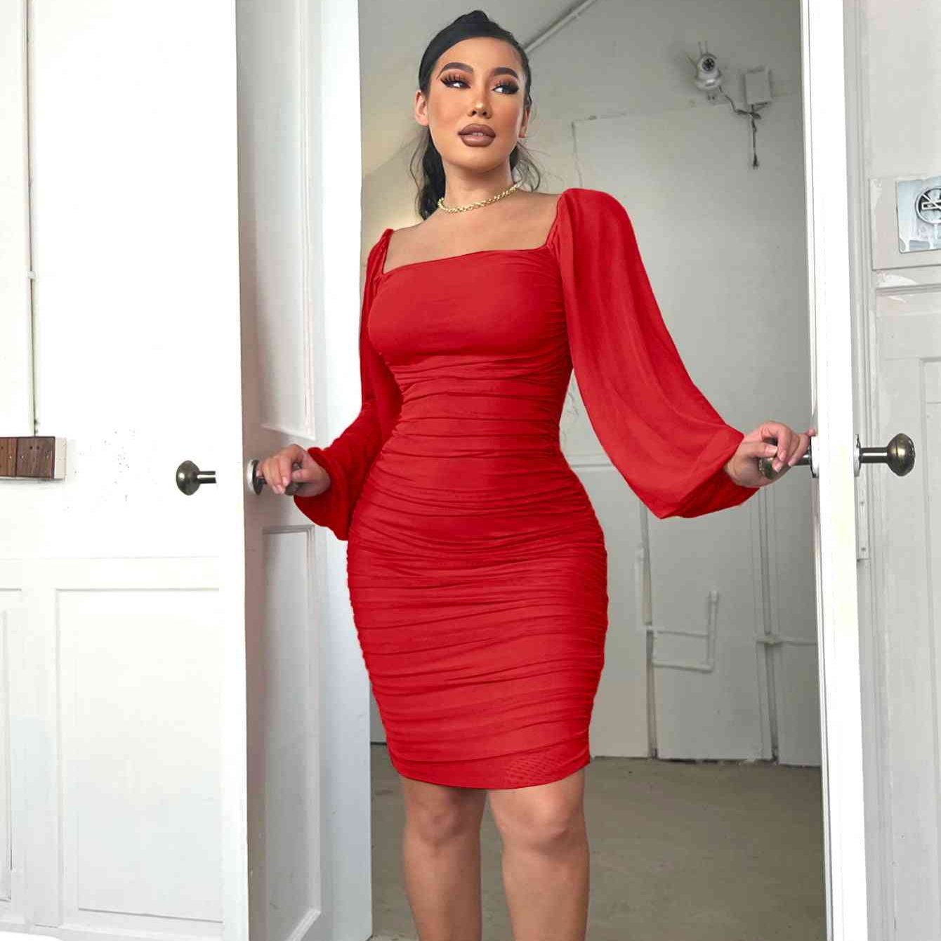 woman wearing a red puff sleeve ruched bodycon mini dress